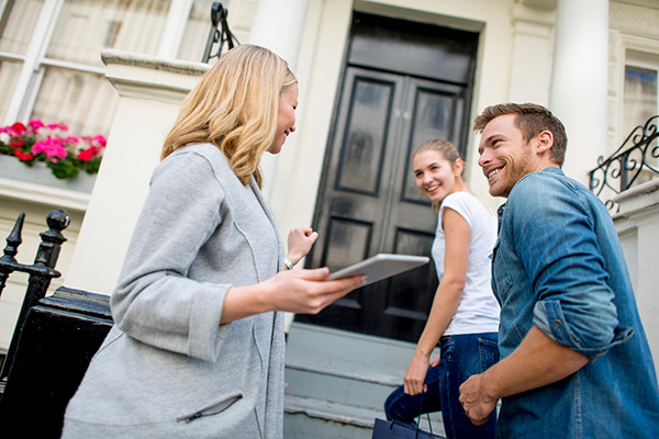 Realtor showing home to young couple